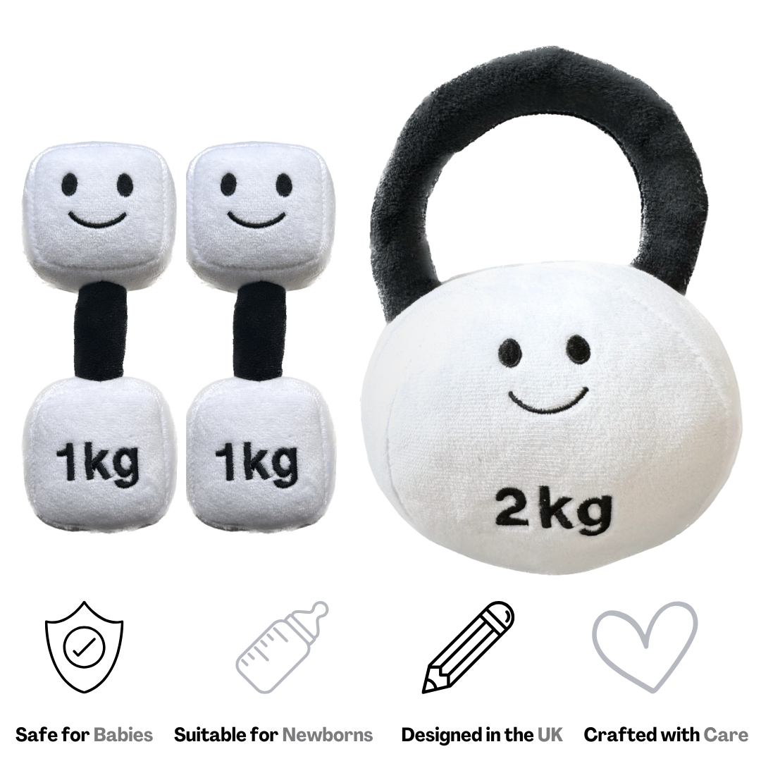 A plush toy set featuring a kettlebell and two dumbbells with a smiling lamb design in black and white, marketed as safe for babies and designed in the UK.