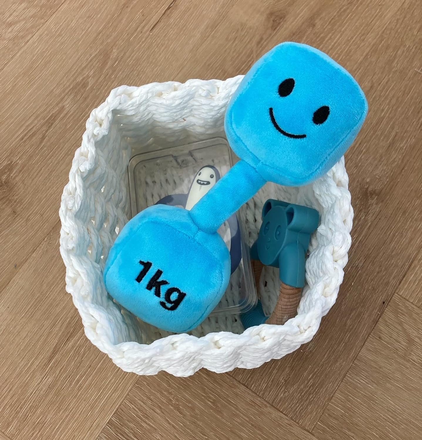 Mystic Blue dumbbell placed in a small basket, adding a charming touch to Hazza Toyz fitness-inspired toys for toddlers.