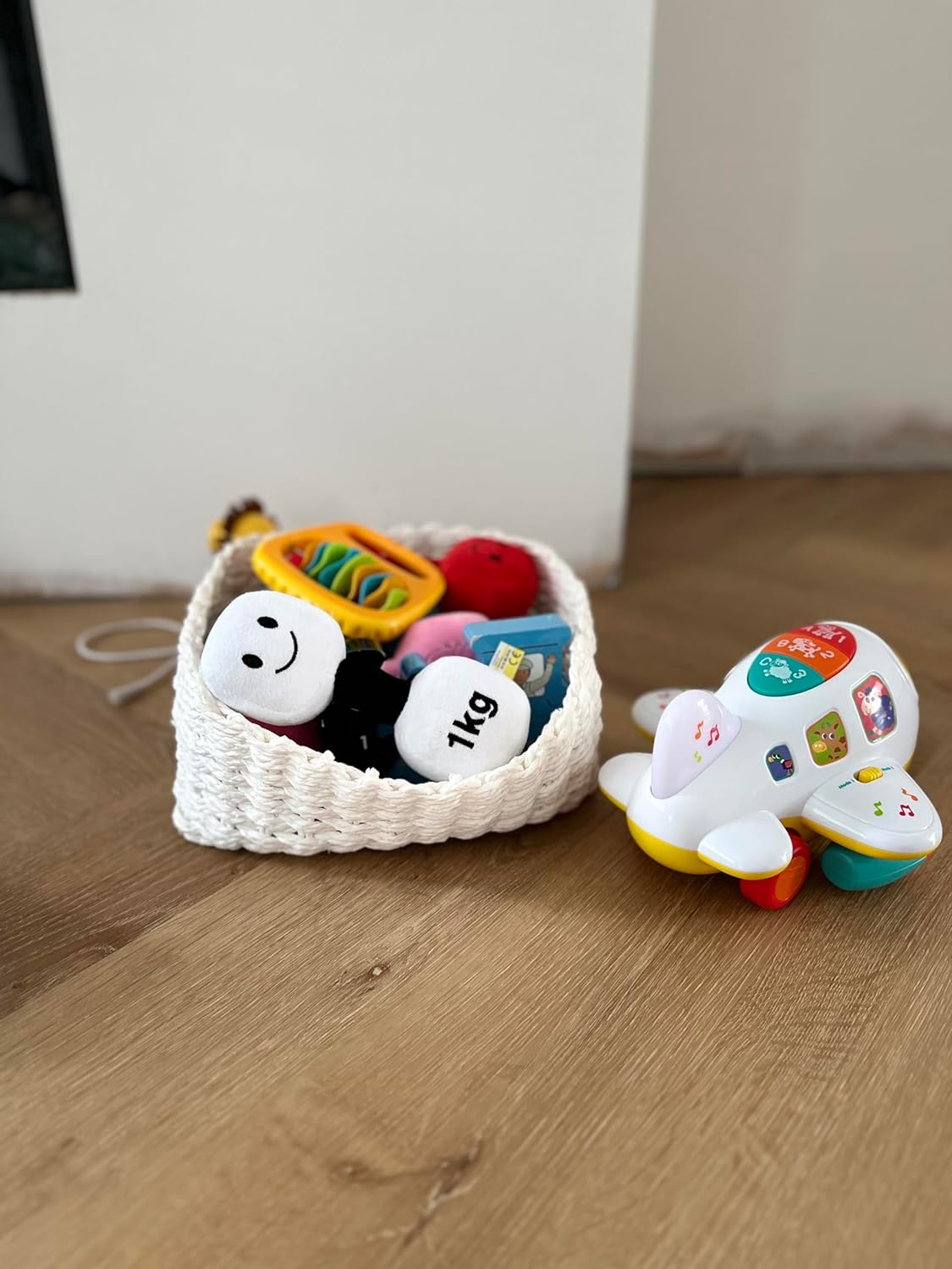 Lamby Black and White dumbbell surrounded by other baby toys, showcasing a playful assortment of Hazza Toyz products designed for toddlers' active and imaginative play.